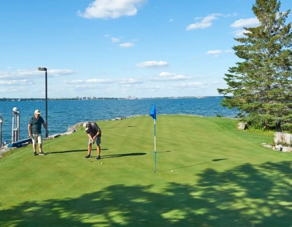 Two men enjoying private golf on the water